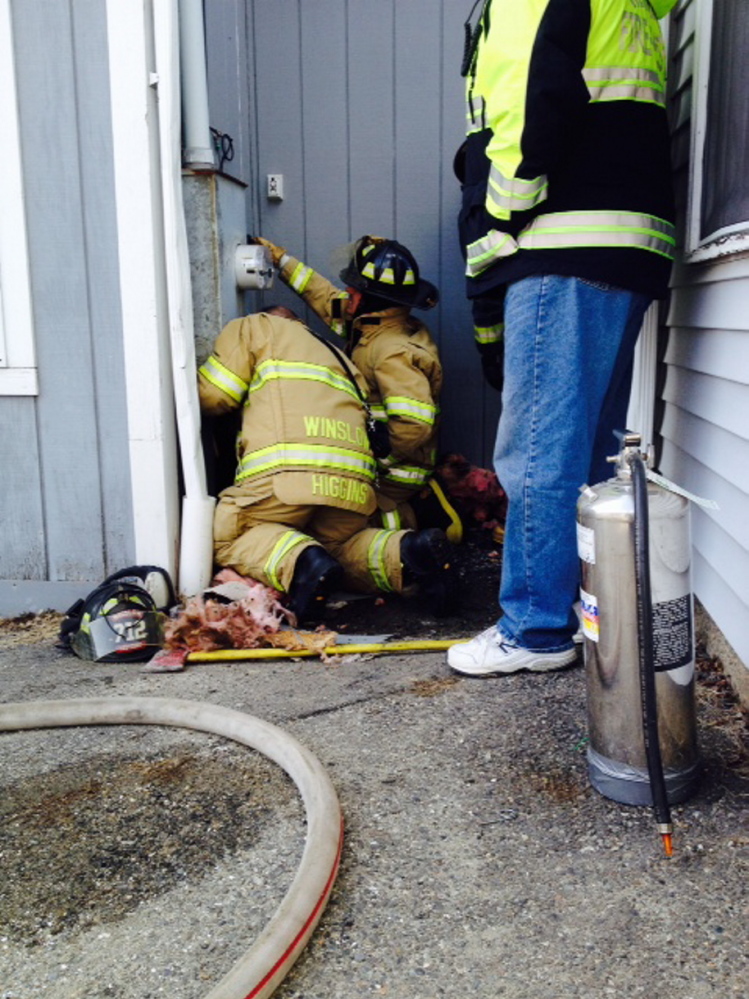 Staff Photo by Amy Calder LOBSTER TRAP EMERGENCY: Winslow firefighters check out the electric box at the Lobster Trap restaurant on Bay Street in Winslow Tueday afternoon. A discarded cigarette that was the apparent cause of a fire that damaged a wall of the building and forced the restaurant to close its doors until Thursday.