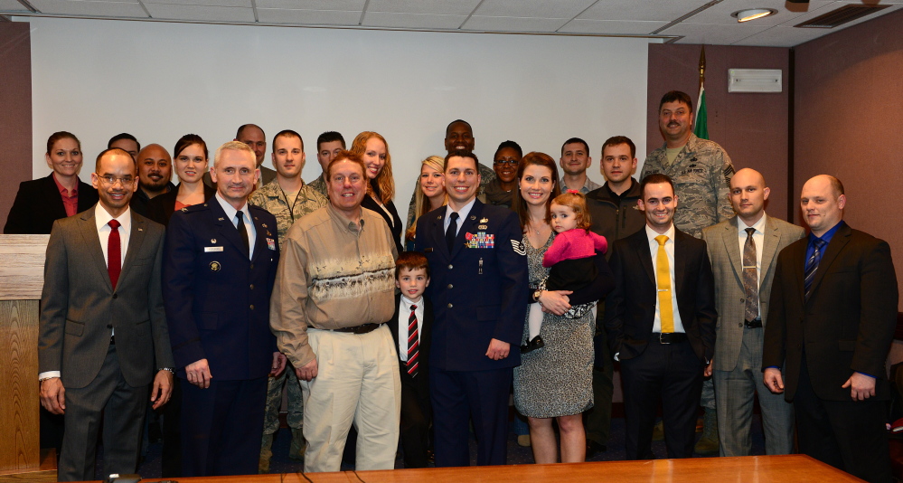 Ceremony: Air Force Tech Sgt. Matthew Bolduc, center, poses with his father, Dennis Bolduc, of Oakland; Sgt. Bolduc’s wife, Janelle; and their two children earlier this month during a ceremony at Aviano Air Base in Friuli-Venezia Giulia, Italy, after he was awarded the Bronze Star, the military’s fourth-highest individual honor, for his heroic service.