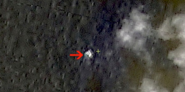 In this March 9, 2014 satellite image seen on the website of the Chinese State Administration of Science, Technology and Industry for National Defense, floating objects are seen at sea next to the red arrow which was added by the source. China's Xinhua News Agency reported Wednesday that the images show suspected debris from the missing Malaysia Airlines jetliner floating off the southern tip of Vietnam.