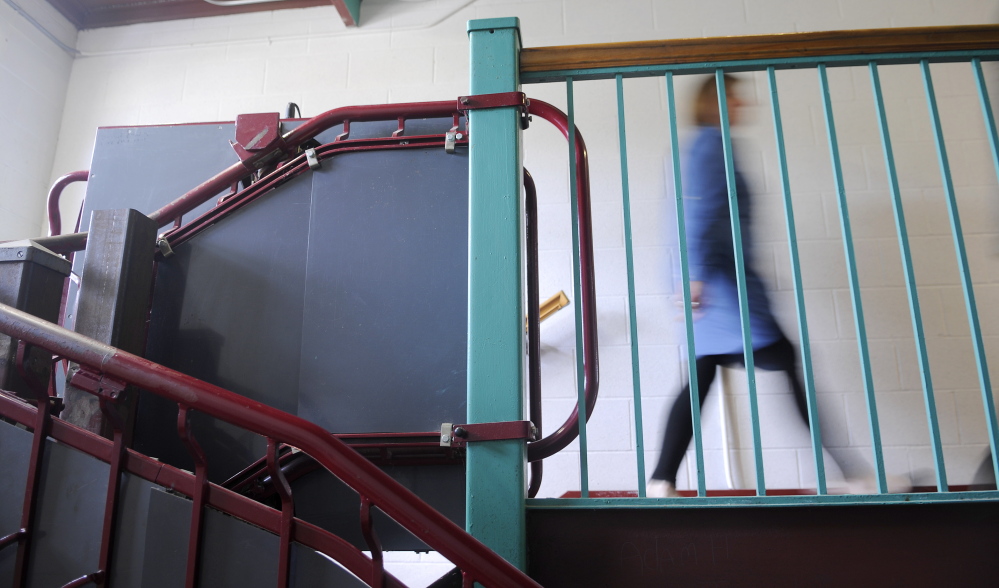 Old lifts: Monmouth pre-k to sixth grade principal Deborah Emery walks by an antiquated lift at the Middle School on Thursday. The school has been added to a state list for renovation.
