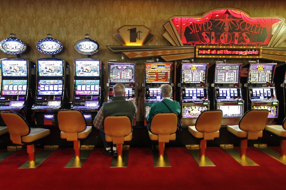 A couple plays the slot machines at Hollywood Slots in Bangor. Lawmakers are considering studying whether there is market potential for more slot machines in the state.