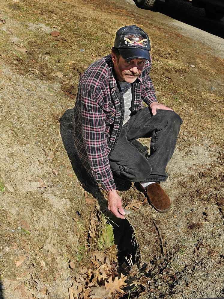 BAD ROADS: Joe Parlin talks about the sharp edges of a metal culvert in front of his lot on Sparrow Drive in the Riverside Drive Village on Thursday in Augusta.
