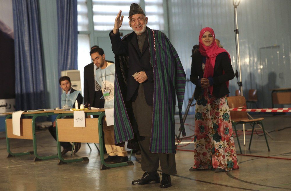 Afghan President Hamid Karzai prepares to vote at a high school near the presidential palace in Kabul on Saturday.