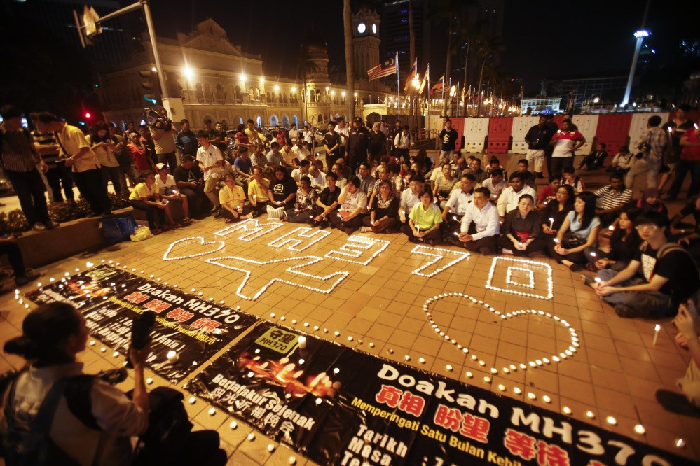Malaysians gather during a candlelight vigil for passengers onboard the missing Malaysia Airlines Flight MH370, in Kuala Lumpur, Malaysia, Monday.