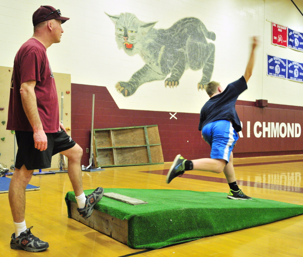 RICHMOND, ME - MARCH 11: Richmond baseball coaches Phil Gardner, left, watches Brendan Emmons pitch during practice on Friday April 11, 2014 at Richmond High School. (Photo by Joe Phelan/Staff Photographer)