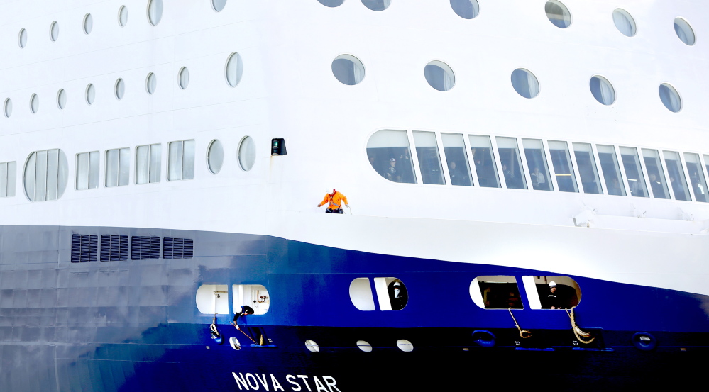 Workers on the Nova Star secure the lines in preparation for docking at Portland’s Ocean Gateway Terminal, where the ship will be inspected by the Coast Guard.