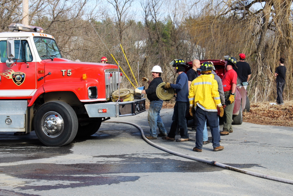 FIRE’S AFTERMATH: Members of the Waterville Fire Department and the forest service pick up on Sunday after putting out a small campfire that started to spread in Winslow.