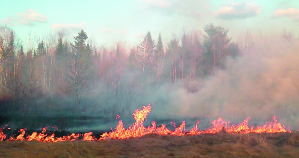 WILDFIRE DANGER: A Clinton wildfire shown in this April 2012 photo burned about 6 acres of grass and brush before it was contained.