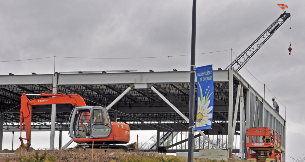 NEW DEVELOPMENT: The Marketplace at Augusta banner hangs in front of a new building under construction Thursday in Augusta.