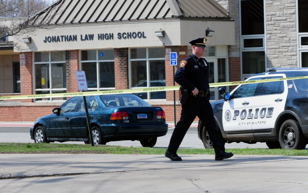 Police remain on scene at Jonathan Law High School after a 16-year-old girl was stabbed to death in Milford, Conn., on Friday.