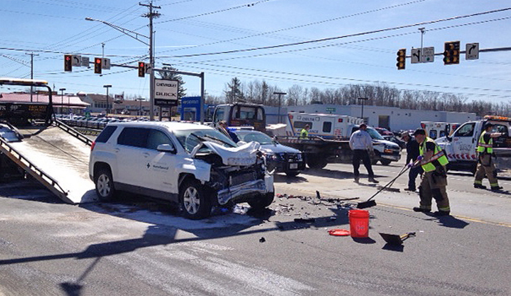 Crash: Police attend to a four-vehicle accident Friday on Kennedy Memorial Drive in Waterville in which four people suffered minor injuries.