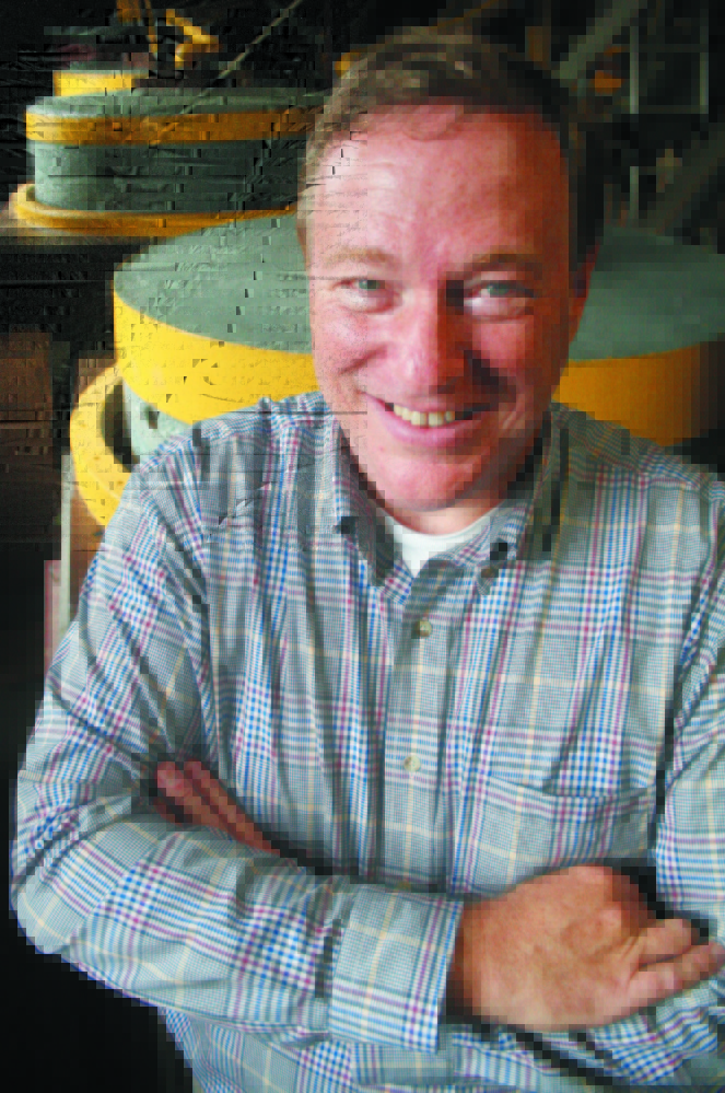 Kevin Raye stands in front of two stone grinders at Raye’s Mustard Mill in Eastport in late September 2012. Raye, who is running for the Republican nomination in the 2nd Congressional District, says his roots in the 2nd district are stronger than those of his opponent, Bruce Poliquin.