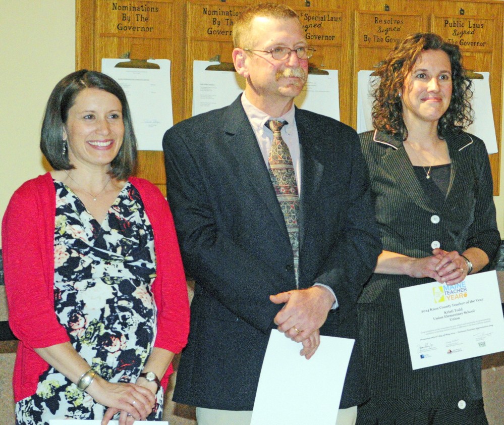 WINNERS: Franklin County Teacher of the Year Sarah Reynolds, left, Kennebec County Teacher of the Year Dan Crocker, and Knox County Teacher of the Year Kristi Todd receive applause during a ceremony on Tuesday to announce the 16 county winners in the Maine Teacher of the Year awards at the State House Hall of Flags in Augusta.