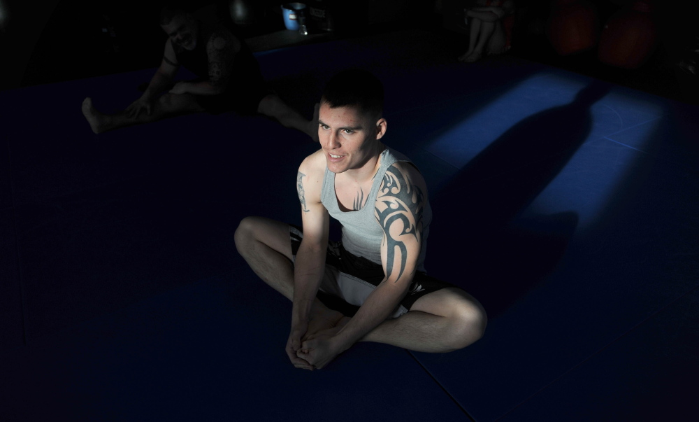 PREPARING: Mixed martial arts participant Phillip Exner stretches before a training session at Littlefield’s Gym in Oakland on Thursday.