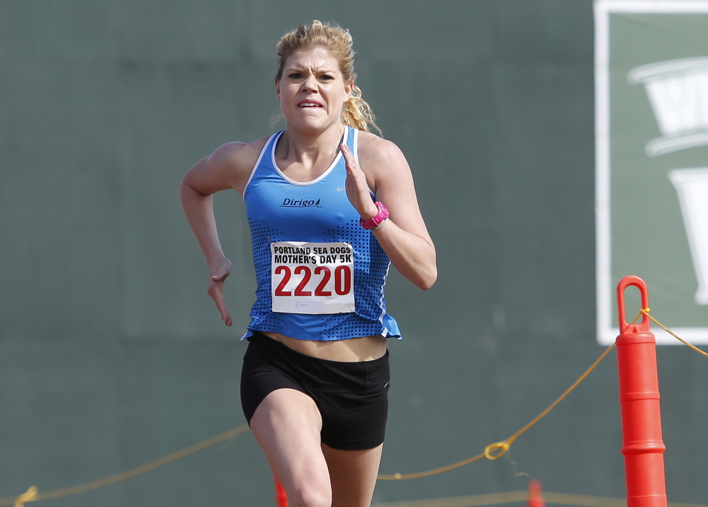 Erica Jesseman nears the finish line at Hadlock Field in winning the women’s division of the Portland Sea Dogs Mother’s Day 5K on Sunday.