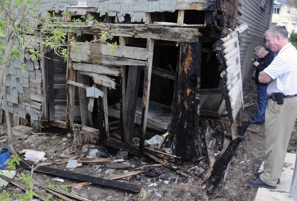 Sand Hill Fire: Maine State Fire Marshal’s Office investigators Sgt. Kenneth Grimes, right, and Ken MacMaster investigate a fire Wednesday at a barn at 110 Northern Ave. in Augusta.