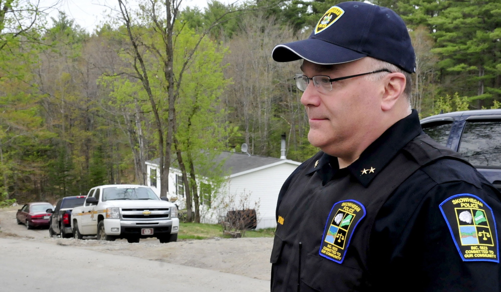 POLICE PRESENCE: Skowhegan Police Chief Ted Blais speaks outside a North School Street residence as police from several agencies searched the home on Wednesday.