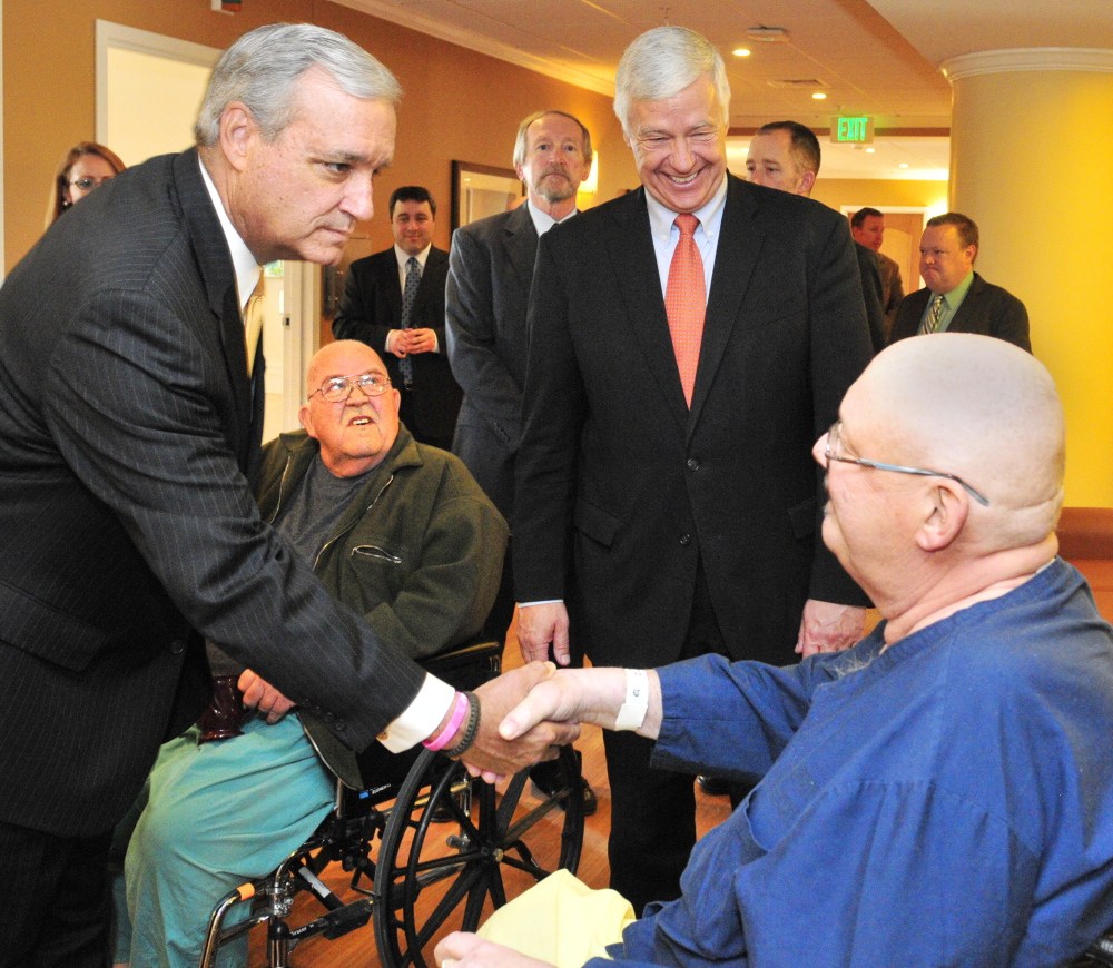 AUGUSTA, ME - The chairman of the House Veterans’ Affairs Committee Rep. Jeff MIller, R-Florida, left, shakes with Bruce Pray, of Winthrop, during a tour of the Togus VA medical center on Friday, April 11, 2014. Pray and Donal Durgin, second from left, also of Winthrop, were chatting when Miller and Rep. Mike Michaud, second from right, passed through.