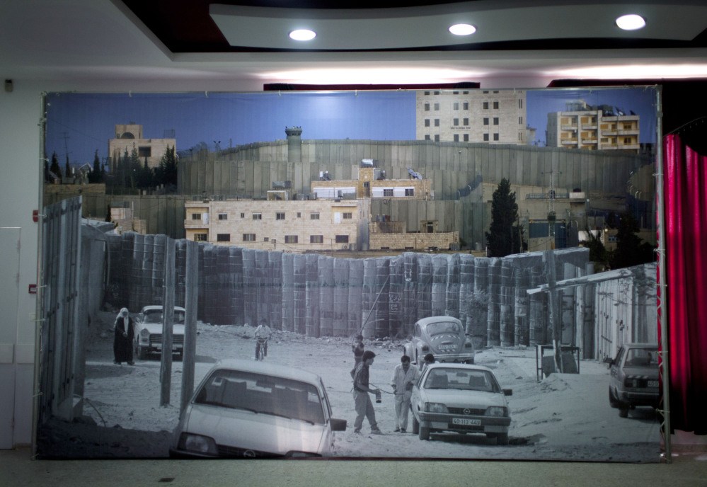 A big poster decorates the main hall in the Dheisheh Palestinian refugee camp that will receive Pope Francis during his scheduled 30-minute visit to the West Bank city of Bethlehem this weekend. Camp residents hope even that brief visit will shine a light on what they say is their forgotten plight. Some 190,000 of the West Bank’s 2.4 million Palestinians live in refugee camps.