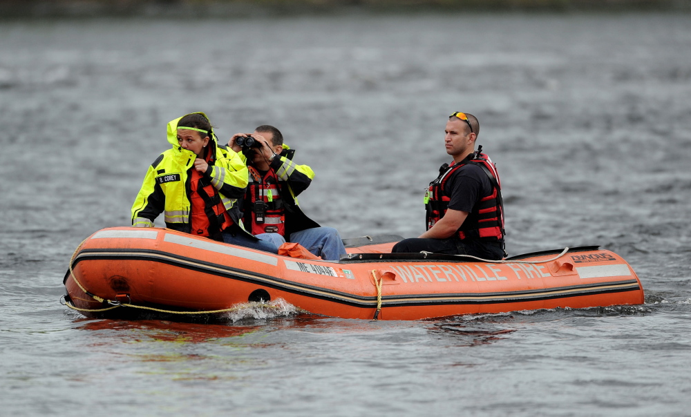 Staff photo by Michael G. Seamans A search crew from the Waterville fire department search the Kennebec River near the Hathaway Center for a reported person in the water on Saturday, May 24, 2014.