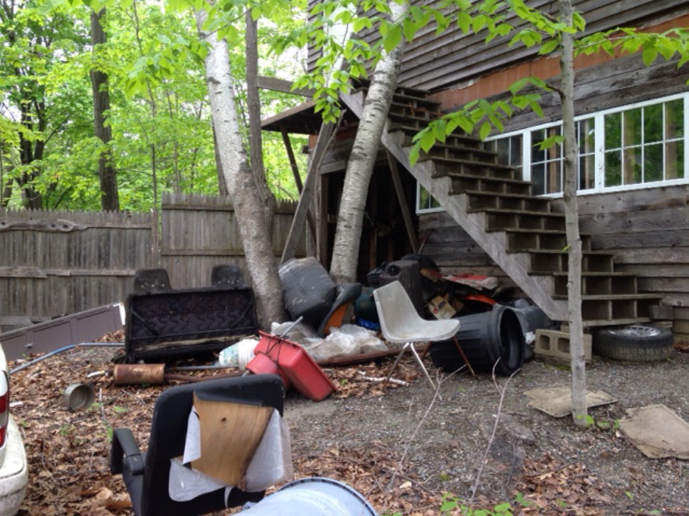 deBRIS: Yards of many homes taken by the City of Waterville for nonpayment of taxes are littered with debris. Neighbors say scenes such as this are hurting their property values.