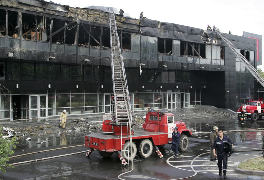 Firefighters work at a burnt ice hockey arena in Donetsk, Ukraine, Tuesday. Early Tuesday, a group of unidentified men stormed Donetsk’s main ice hockey arena, which was to host the 2015 world championships and set it ablaze, according to the mayor’s office.