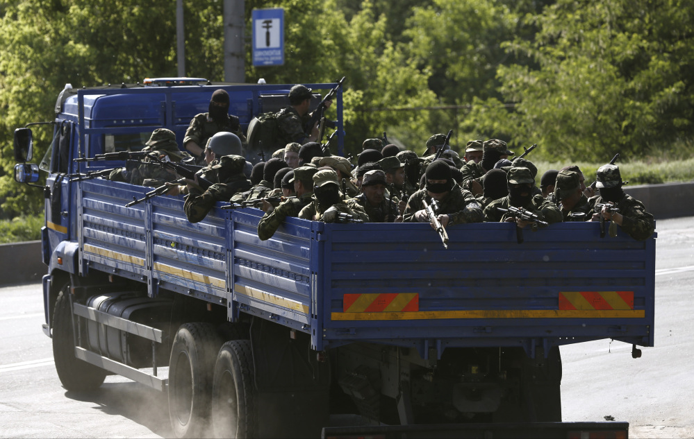Pro-Russian militia arrive to take positions outside the airport in Donetsk, Ukraine.