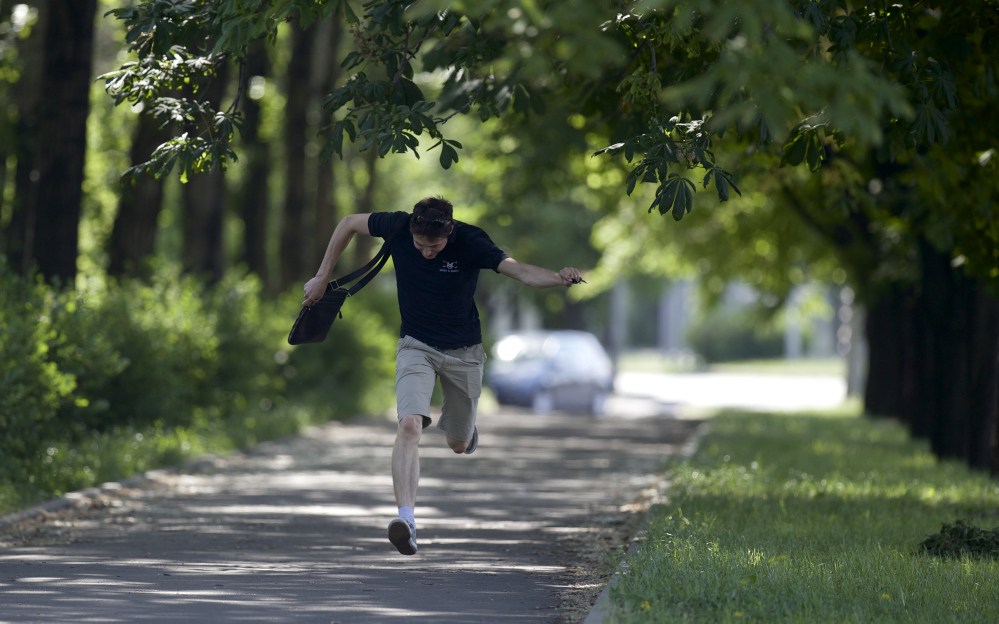 A local resident runs for cover during fighting around the airport, outside Donetsk, Ukraine, on Monday. Ukraine’s military launched air strikes Monday against separatists who had taken over the airport in the eastern capital in what appeared to be the most visible operation of the Ukrainian troops since they started a crackdown on insurgents last month.