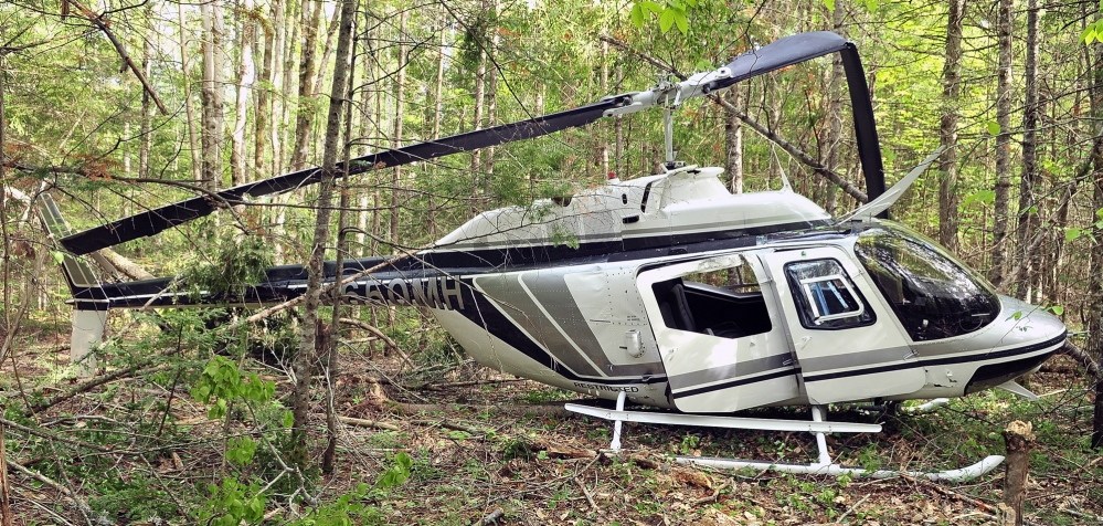 CRash site: A helicopter rests in the wood after a crash landing on Friday in Whitefield. The pilot, Mike Connolly, was not injured.