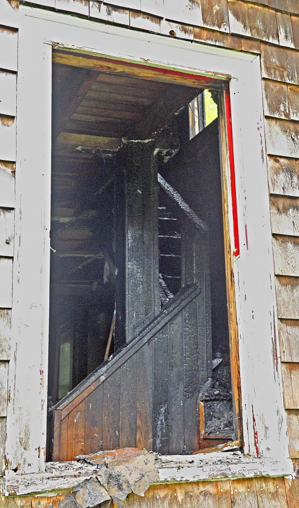 HOME LOST: A window frames fire damage in the Lunt home Saturday after a fire heavily damaged the home at 4 Pine Knoll Road in Winthrop.