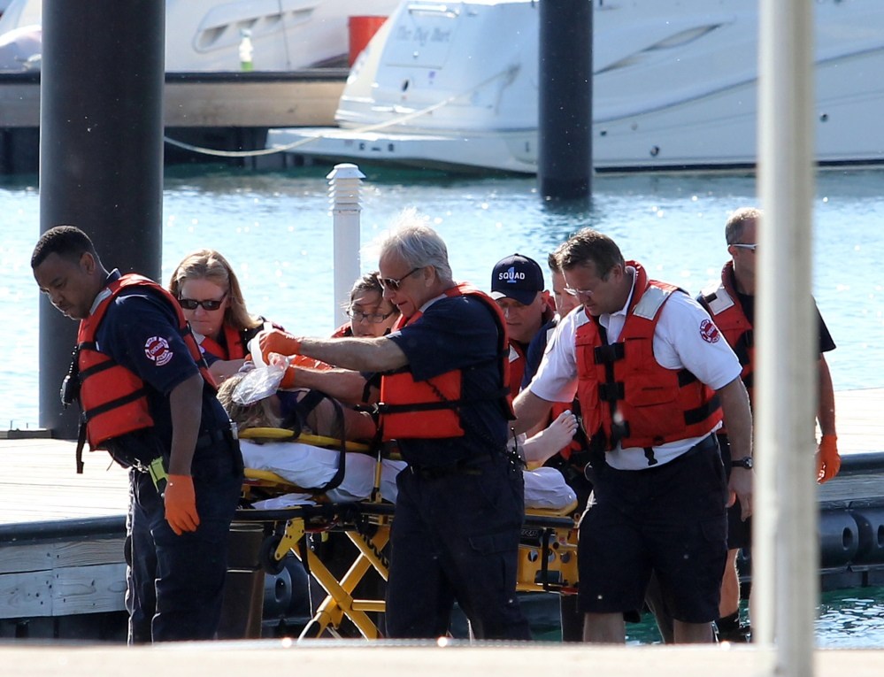 A woman is rescued from the South Side stretch of Lake Michigan, Sunday, after a boat she was in capsized Saturday night miles from Chicago’s shoreline.