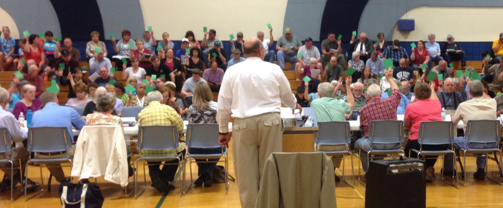 Staff Photo by Jesse Scardina Residents vote at Monday’s Town Meeting in Vassalboro.