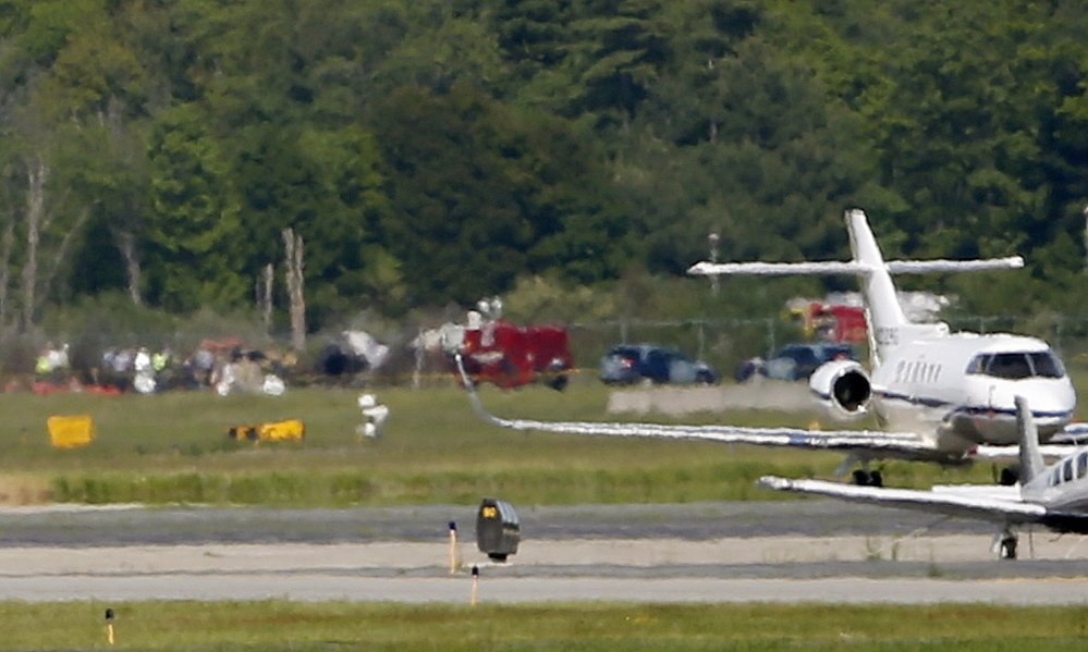 The Associated Press The site of a plane crash is seen in the distance, across Hanscom Field in Bedford, Mass., Sunday. The co-owner of the Philadelphia Inquirer newspaper, Lewis Katz, was killed along with six other people in a fiery plane crash in Massachusetts, just days after reaching a deal that many hoped would end months of infighting at the newspaper and help restore it to its former glory.