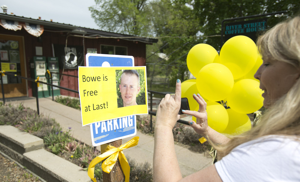 Diane Walker takes a picture of a sign celebrating U.S. Army Sgt. Bowe Bergdahl’s release in front of Zaney’s coffee shop in Hailey, Idaho.