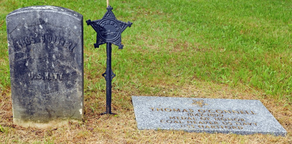 Staff photo by Joe Phelan HONORED: Town cemetery sexton Tom Reed recently installed a new marker for Thomas O’Connell, who won the Medal of Honor in the Civil War and is buried in Rest Haven Cemetery in Windsor.