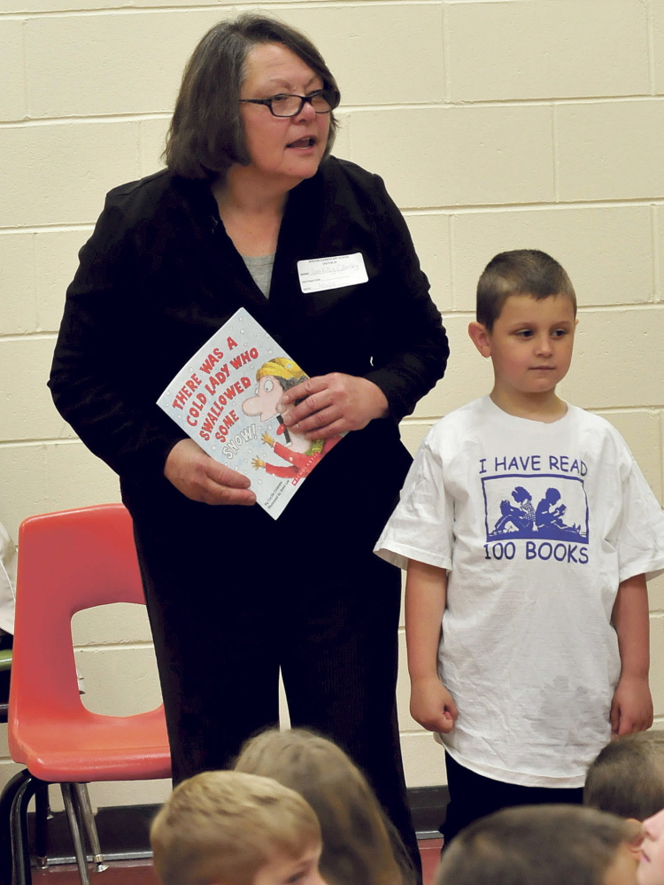 Staff photo by David Leaming
LITERATE: Lois Kilby Chesley, president of the Maine Education Association and Benton Elementary School student Alex Johnson speak to students before selecting books through the Read Across America program on Thursday.