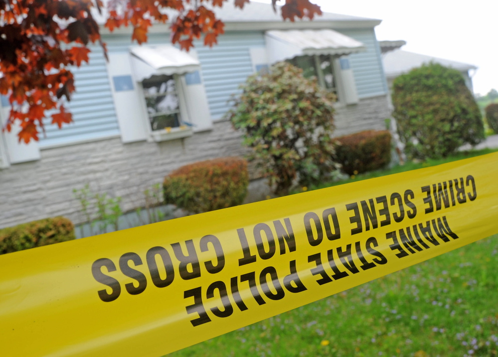 Staff photo by Michael G. Seamans Crime scene: An investigator with the Maine State Police Major Crimes Unit dusts for fingerprints at the residence of Aurele Fecteau, 92, who was found dead in his home on Brooklyn Street in Waterville on Friday, May 23.