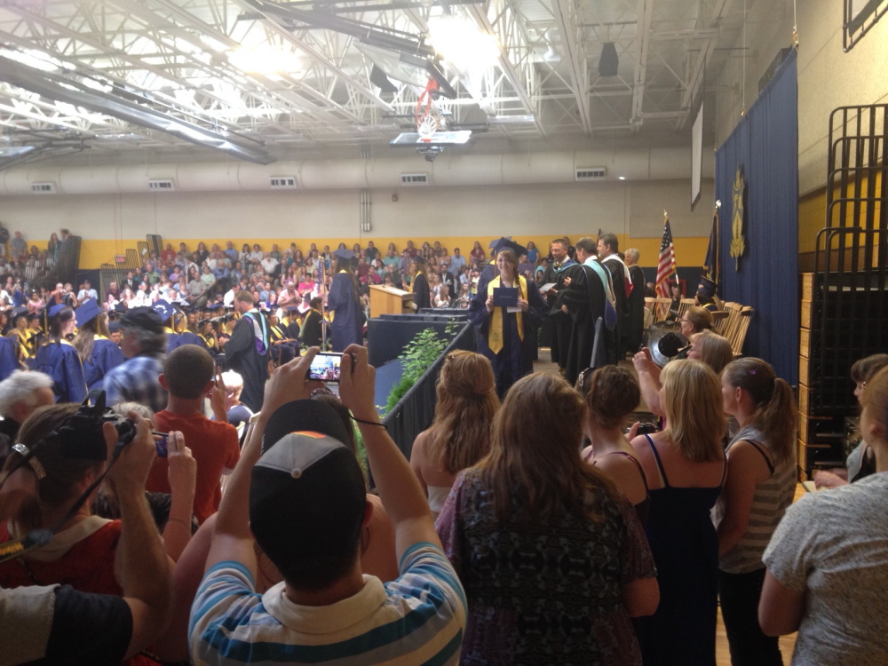 Staff photo by Kaitlin Schroeder Snap and Gown: Family and friends of Mt. Blue High School graduates crowd around the stage to get photos of their graduates Saturday in Farmington.