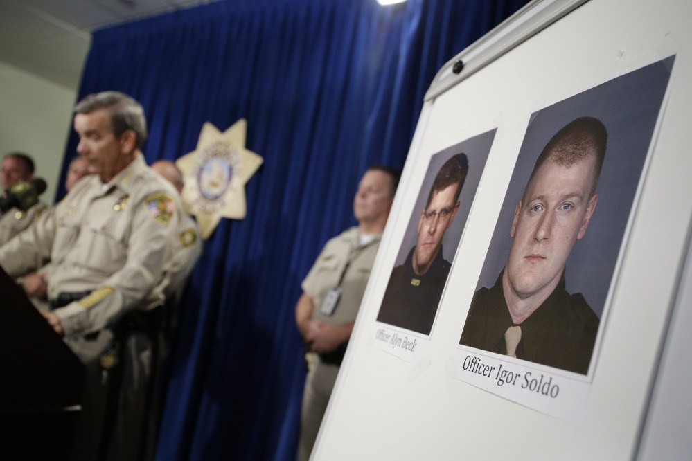 The Associated Press Sheriff Doug Gillespie, left, speaks at a news conference on the shooting of two Las Vegas Metropolitan Police Department officers Sunday in Las Vegas. The two officer killed were Alyn Beck and Igor Soldo.