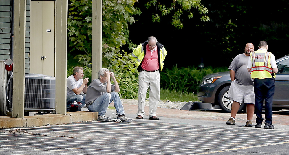 Freeport police and fire crew at the scene of a fatal accident of a landscaping crew member behind 136-140 Main Street in Freeport on Tuesday. A worker for a landscaping crew was killed just before 9 a.m. Authorities would not release the circumstances of the accident but said it appears a piece of equipment may have fallen on the victim. Tim Greenway/Staff Photographer