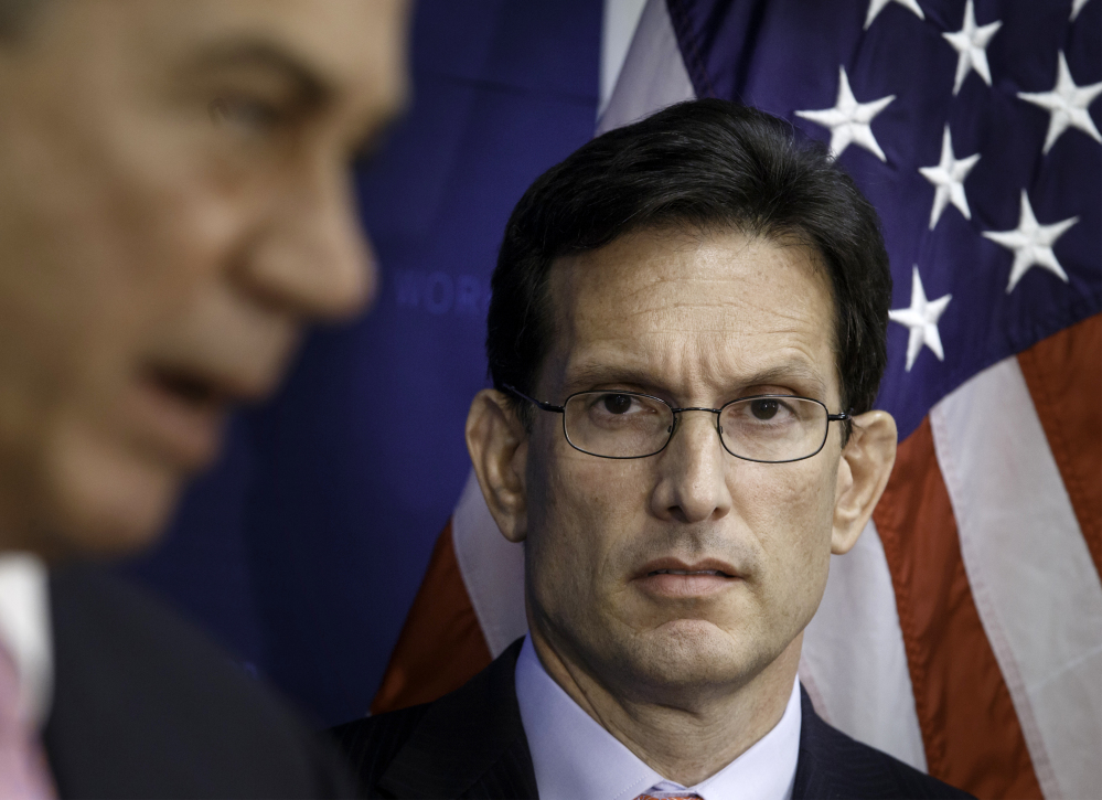 House Majority Leader Eric Cantor listens as House Speaker John Boehner makes remarks during a news conference on Capitol Hill Tuesday.