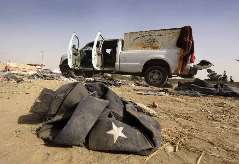A vehicle belonging to Iraqi security forces is left on a road at a checkpoint in east Mosul, one day after radical Sunni Muslim insurgents seized control of the city. The insurgents extended their control to an area farther south that includes Iraq’s biggest oil refinery.