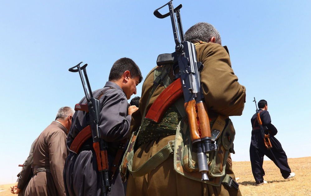 Kurdish Peshmerga security forces stand guard in the outskirts of the northern city of Mosul, Iraq, on Saturday. Fighters from the al-Qaida splinter group, drawing support from former Saddam Hussein-era figures and other disaffected Sunnis, have made dramatic gains in the Sunni heartland north of Baghdad after overrunning Iraq’s second-largest city of Mosul on Tuesday.