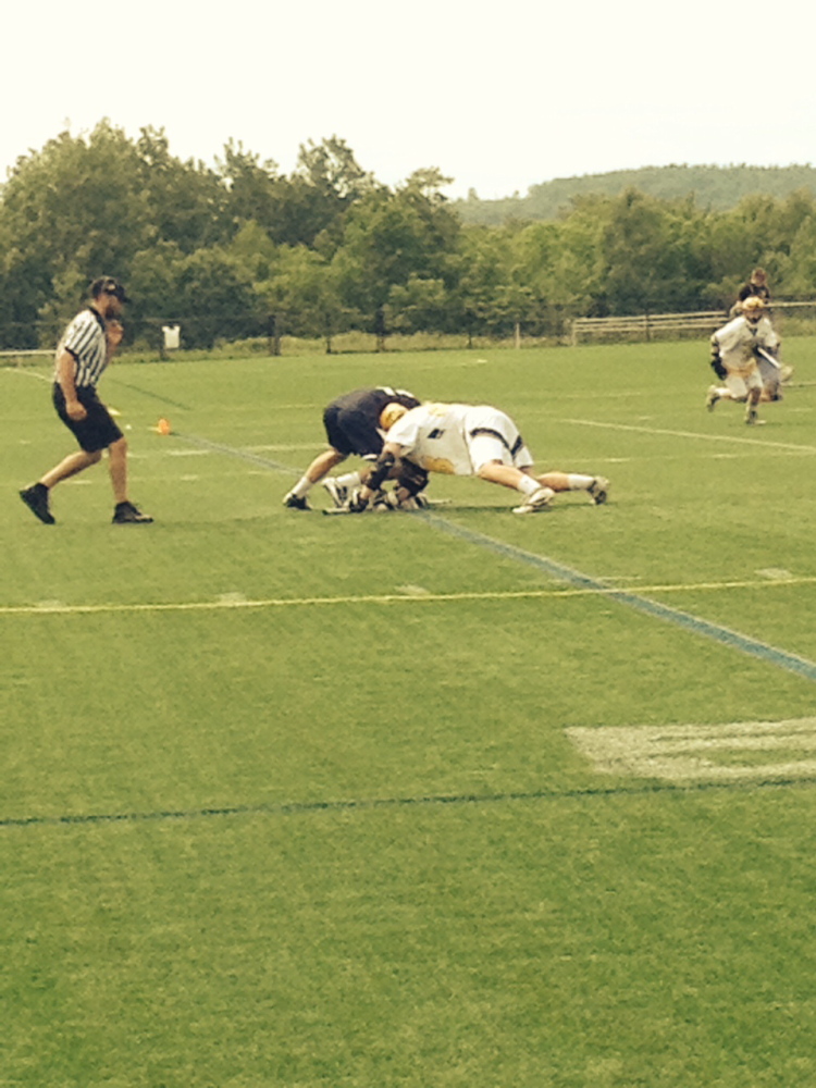 Clipper Winner: Maranacook/Winthrop junior midfielder Josh Murphy battles Yarmouth sophomore Walter Conrad for the ball on a faceoff during the Eastern B semifinal game Saturday. The Clippers prevailed,10-7.