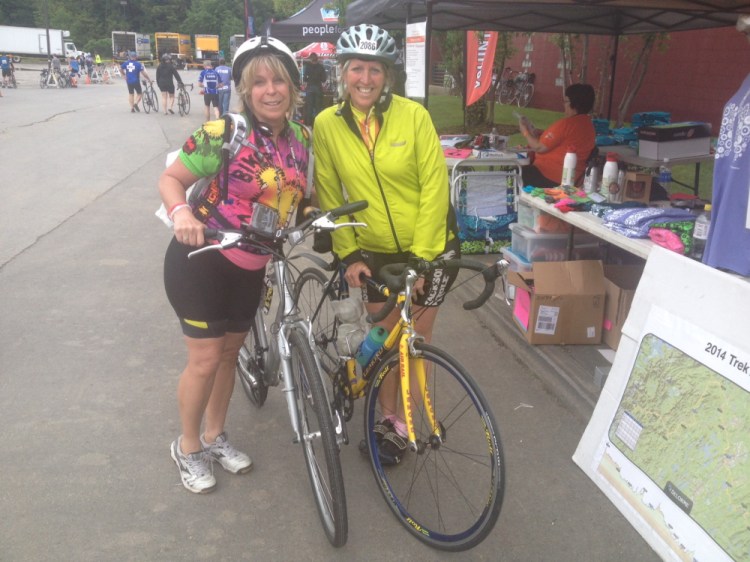 Two Down: Sisters Diana LeRoux, left, and Joanne Mason, right, relax at Colby College in Waterville after crossing the finish line for the second leg of the Trek Across Maine on Saturday.