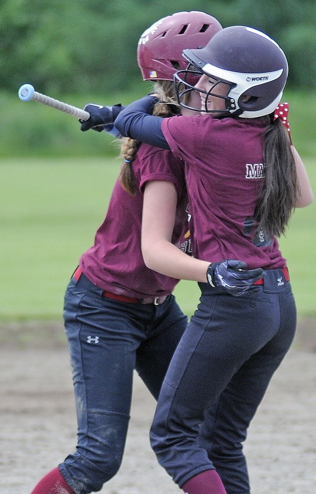 Winners: Meranda Martin, right, hugs teammate Kelsea Anair Saturday after Anair batted Martin for the game winning run during a softball match up in Richmond.