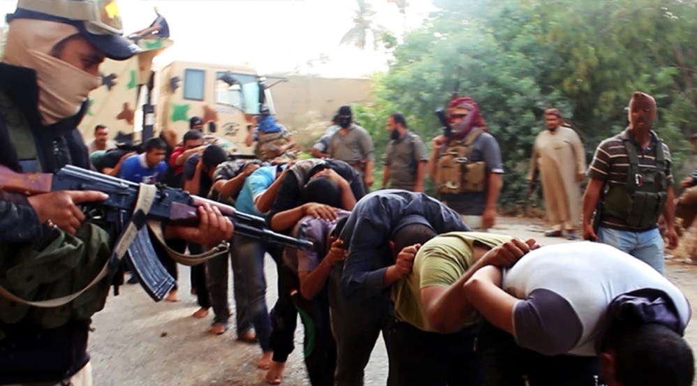 This image posted on a militant website on Saturday appears to show militants from the al-Qaida-inspired Islamic State of Iraq and the Levant (ISIL) leading away captured Iraqi soldiers dressed in plain clothes after taking over a base in Tikrit, Iraq.