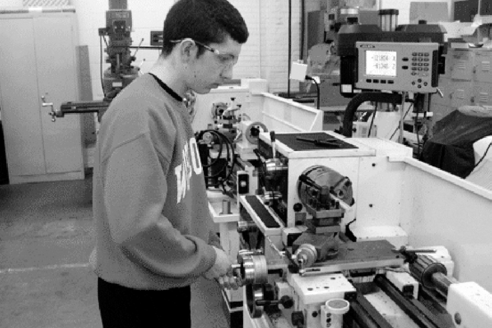 21st century career: Chris Ronsman, a junior at Green Bay West High School in Wisconsin, works at a manual lathe turning down a piece of aluminum round stock. Employers in many states are trying to encourage students to consider careers in manufacturing.