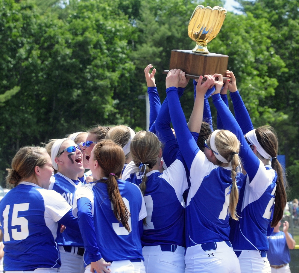 Top Dog: Madison Bulldogs team holds aloft the golden glove trophy emblematic of winning the class C softball state championship game 1-0 over Calais on Saturday in Standish.