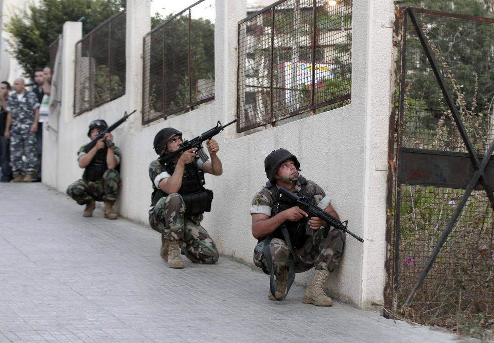Lebanese army soldiers take their positions outside the Duroy Hotel where a suicide bomber blew himself up in his room, in Beirut, Lebanon, on Wednesday.